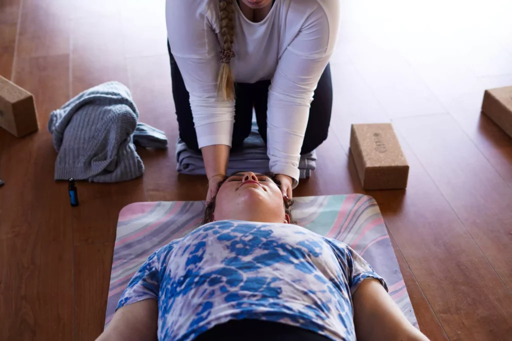 Yoga teacher working with yoga student